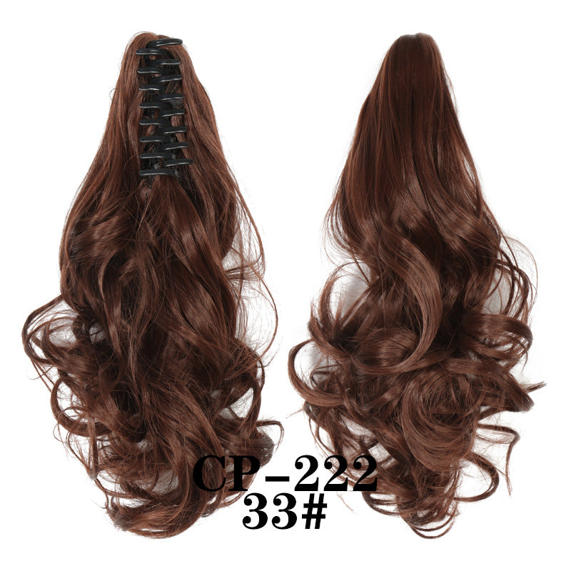 Wavy ponytail with curly hair and a tiger clip