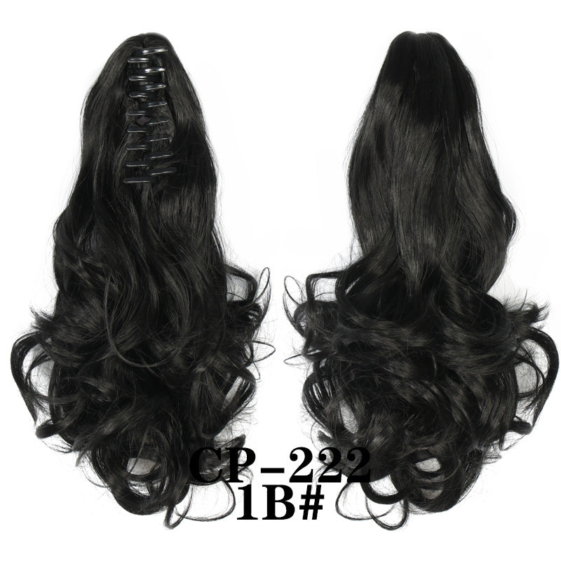 Wavy ponytail with curly hair and a tiger clip